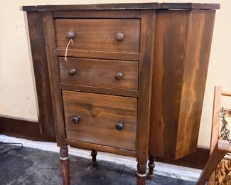 Anique Martha Washington style sewing cabinet featuring three central drawers