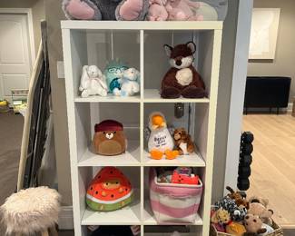 White cubbie unit and plush
