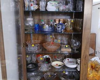 Photo — China Cabinet Full of Cut Glass, Crystal & Fine China Tags: cut crystal glassware, pressed glass bowls, cranberry glass, milk glass hen dish, vintage stemware, blue and white china teapot, etched crystal, crystal candy dish, brandy snifters A gorgeous, well-stocked china cabinet loaded with glassware for collectors: cut crystal bowls and dishes, pressed pink depression glass, a milk glass hen-on-nest dish, brandy snifters (pair for $5), and a blue-and-white porcelain teapot. Shelves also hold etched crystal stemware, cranberry glass, amber glass pitchers, and delicate hand-painted china plates and dishes — a serious selection for any glassware or china enthusiast.