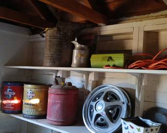Skelly Oil Tins, Ford Hubcap & Vintage Garage Finds Tags: Skelly Oil cans, vintage gear lubricant tin, grease can, oil spouted can, Ford hubcap, wheel cover, galvanized funnel can, metal toolbox, extension cord, garage collectibles A great shelf of vintage garage and automotive collectibles: red and gold Skelly Oil tins (Tagolene gear lubricant and multi-purpose grease), an old red fuel can, a spouted oil can, and a classic Ford hubcap priced at $20. Above, a rustic galvanized funnel can, an aluminum oil pitcher, a lime-green metal toolbox, and coiled extension cord round out this handyman’s shelf — perfect for gearheads and vintage advertising collectors.