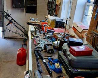 Garage Bench Vise, Power Tools & Mower Bags Tags: Bardco bench vise, garage tool bench, gas can, ratchet straps, hand tools, mower grass catcher, tool boxes, garage workshop A solid Bardco bench vise ($15) anchors this well-stocked garage bench, loaded with hand tools, ratchet straps, a red gas can, and multiple tool boxes. Mower grass catcher bags hang on the wall above, along with more garage essentials — a great grab for anyone equipping a workshop.