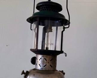 Vintage Coleman Double-Mantle Camping Lantern Tags: vintage Coleman lantern, double mantle gas lantern, camping collectible, glass globe lantern, antique outdoor gear A classic vintage Coleman double-mantle gas lantern with its original glass globe and green-painted vents — a great functional collectible for camping enthusiasts or outdoor decor lovers. Shows honest age and patina on the tank, consistent with a well-used piece from a working farm.
