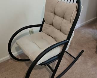 Modern Metal Rocking Chair with Slatted Back and Beige Cushions