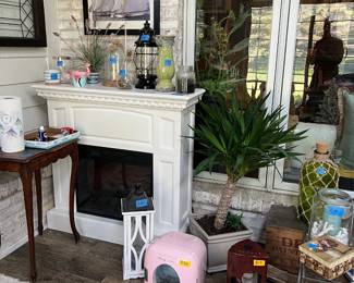 Fireplace, mini fridge, wine fridge, plants, table, staine glass, lead glass, lanterns, candlesticks, rugs