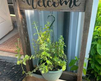 Welcome Plant Stand  Good condition. Does not come with plant. Has name on back but is just stickers and can be removed. 40” tall x 28” x 12” 