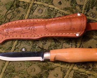 J. Marttiini Finnish fillet/fishing knife, marked Marttiini Finland, with its original decorated leather sheath. The birch handle and narrow upswept blade are typical of Marttiini fishing knives.