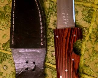 Spectrum Knife fixed-blade hunting/skinning knife with a full-tang wood handle and leather sheath.