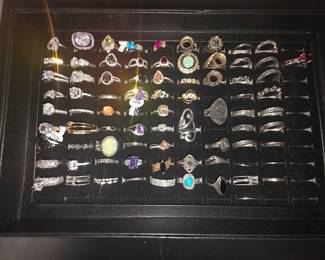 Bohemian tray: Vintage unworn silver tone fashion rings featuring crown, tiara, lotus, floral, feather, and celestial designs with colorful accent stones. CZ and colored stone tray: Vintage unworn silver tone fashion rings featuring halo, teardrop, and solitaire inspired designs with colorful accent stones in various cuts and settings.