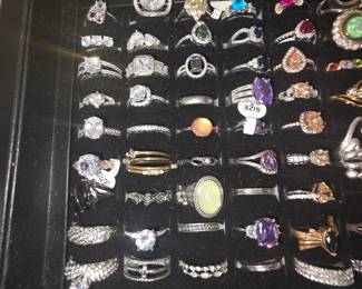 Bohemian tray: Vintage unworn silver tone fashion rings featuring crown, tiara, lotus, floral, feather, and celestial designs with colorful accent stones. CZ and colored stone tray: Vintage unworn silver tone fashion rings featuring halo, teardrop, and solitaire inspired designs with colorful accent stones in various cuts and settings.