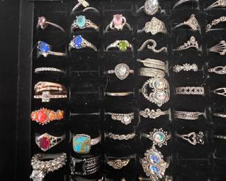 Bohemian tray: Vintage unworn silver tone fashion rings featuring crown, tiara, lotus, floral, feather, and celestial designs with colorful accent stones. CZ and colored stone tray: Vintage unworn silver tone fashion rings featuring halo, teardrop, and solitaire inspired designs with colorful accent stones in various cuts and settings.