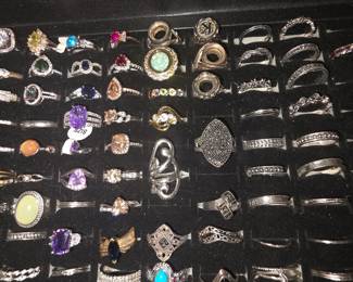 Bohemian tray: Vintage unworn silver tone fashion rings featuring crown, tiara, lotus, floral, feather, and celestial designs with colorful accent stones. CZ and colored stone tray: Vintage unworn silver tone fashion rings featuring halo, teardrop, and solitaire inspired designs with colorful accent stones in various cuts and settings.