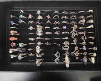 Bohemian tray: Vintage unworn silver tone fashion rings featuring crown, tiara, lotus, floral, feather, and celestial designs with colorful accent stones. CZ and colored stone tray: Vintage unworn silver tone fashion rings featuring halo, teardrop, and solitaire inspired designs with colorful accent stones in various cuts and settings.