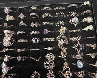 Bohemian tray: Vintage unworn silver tone fashion rings featuring crown, tiara, lotus, floral, feather, and celestial designs with colorful accent stones. CZ and colored stone tray: Vintage unworn silver tone fashion rings featuring halo, teardrop, and solitaire inspired designs with colorful accent stones in various cuts and settings.