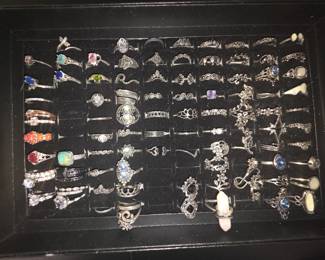 Bohemian tray: Vintage unworn silver tone fashion rings featuring crown, tiara, lotus, floral, feather, and celestial designs with colorful accent stones. CZ and colored stone tray: Vintage unworn silver tone fashion rings featuring halo, teardrop, and solitaire inspired designs with colorful accent stones in various cuts and settings.
