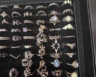 Bohemian tray: Vintage unworn silver tone fashion rings featuring crown, tiara, lotus, floral, feather, and celestial designs with colorful accent stones. CZ and colored stone tray: Vintage unworn silver tone fashion rings featuring halo, teardrop, and solitaire inspired designs with colorful accent stones in various cuts and settings.