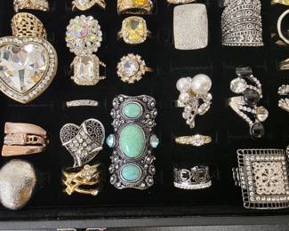 Vintage and fashion jewelry collection featuring rings, earrings, bracelets, necklaces, and accessories in gold and silver tone finishes