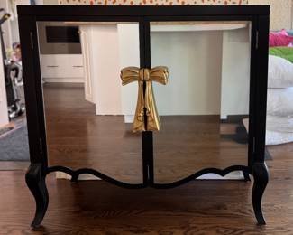 Hollywood Regency Style Glass Front Cabinet with Bow Handles. Has Peel & Stick Wallpaper Topper. Measures 38" W x 15" D x 36 1/2" H. Photo 1 of 3.