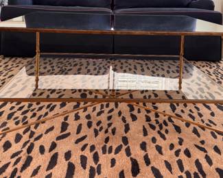 Uttermost Henzier Gilded Metal Coffee Table with Mirrored Top and Glass Shelf. Measures 38" L x 28" W x 19 1/2 " H. Photo 1 of 4.