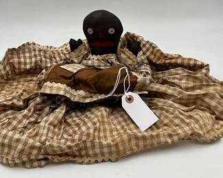antique primitive folk art doll is made from cloth and features hand-sewn button eyes and a bright red mouth