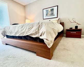 Low-profile dark wood platform bed frame.