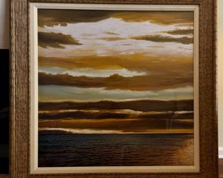 Large dramatic sunset/sunrise over a dark horizon.