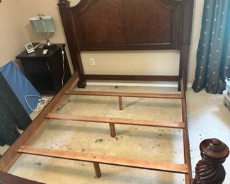 Victorian-style dark cherry queen bed features ornate carvings and spiraled posts. Includes headboard, footboard & sideboard. Matching nightstand available.