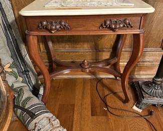 This table features an ornate, solid walnut base that supports a white marble top. Dramatic curves & sculptural wood detailing make this piece a beautiful addition to any space.