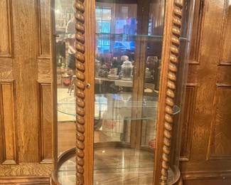 Set of curio cabinets crafted from oak with mirrored back interior to display items. 2 glass interior shelves and oak base provide space to display items of various sizes. We have 2 available.
