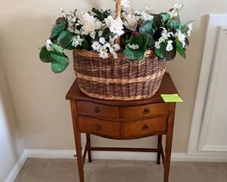 Vintage Wicker Basket with White Floral Arrangement on a Small Wooden Side Table