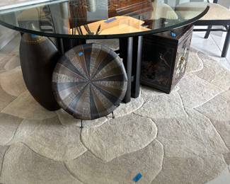 Thick luxurious glass on top of pretty black base. The pieces under it and the lotus rug sre for sale too.