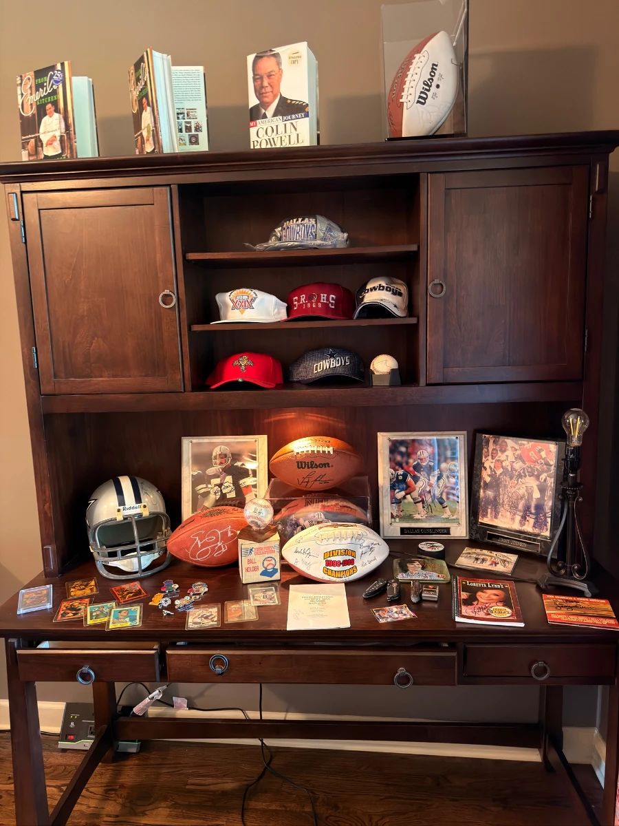 Sports memorabilia display — signed footballs, caps, framed photos