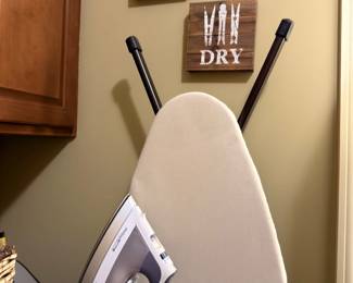 Ironing board with iron and laundry decor signs