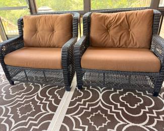 Pair of wicker patio armchairs with cushions