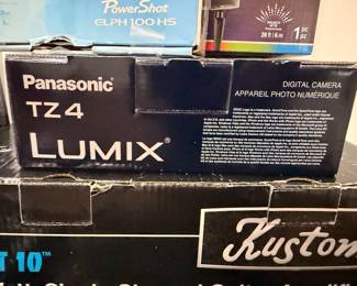 Panasonic Lumix and Canon cameras in boxes