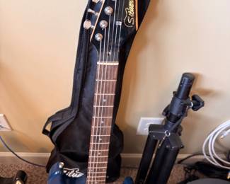 Silvertone blue electric guitar with stand