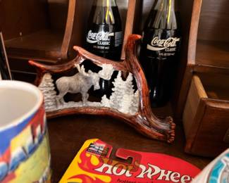 Carved moose antler decor and vintage Coke bottles