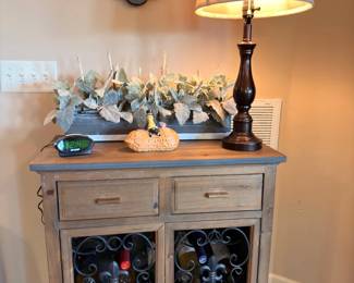 Wine storage cabinet with wrought iron rack doors