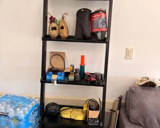Black ladder shelf with assorted items