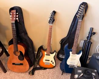 Acoustic and electric guitars with cases