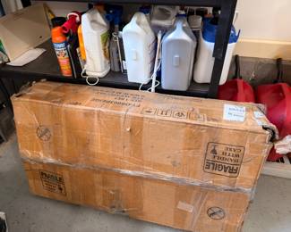 Garage shelf with cleaning supplies and boxed item