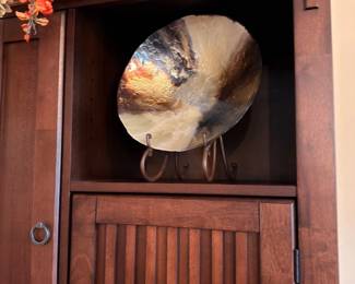Wooden display cabinet with decorative art charger