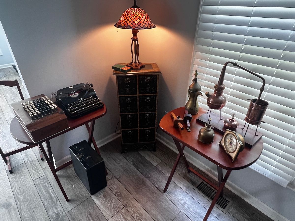 Antique curiosities. Typewriter, 1920s computer calculator, Bunsen burner, binoculars