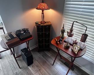 Antique curiosities. Typewriter, 1920s computer calculator, Bunsen burner, binoculars