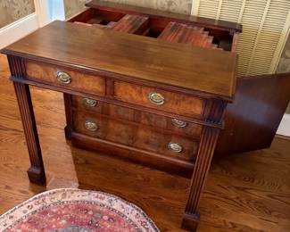 collapsible dining table -pull out the legs and leaves are stored inside cabinet - great way to expand your table for big holiday meals