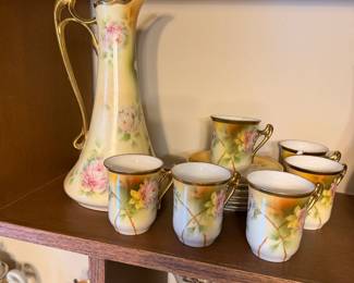 porcelain hot cocoa pot with cups and saucers