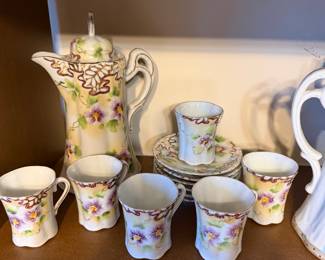 porcelain hot cocoa pot with cups and saucers