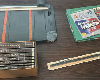 Lot 32: Fiskars Paper Trimmer, Table, McGuffey Reader Book Set, Rand McNally TripMaker 1997, and Cutting Strip