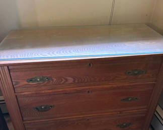 Lot 245: Wooden dresser with glass top and three drawers