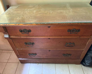 Lot 247: Three-drawer wooden dresser with glass top