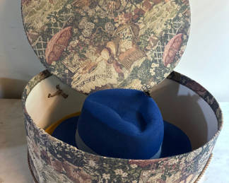 Lot 224: Round tapestry hatbox with blue and yellow hats